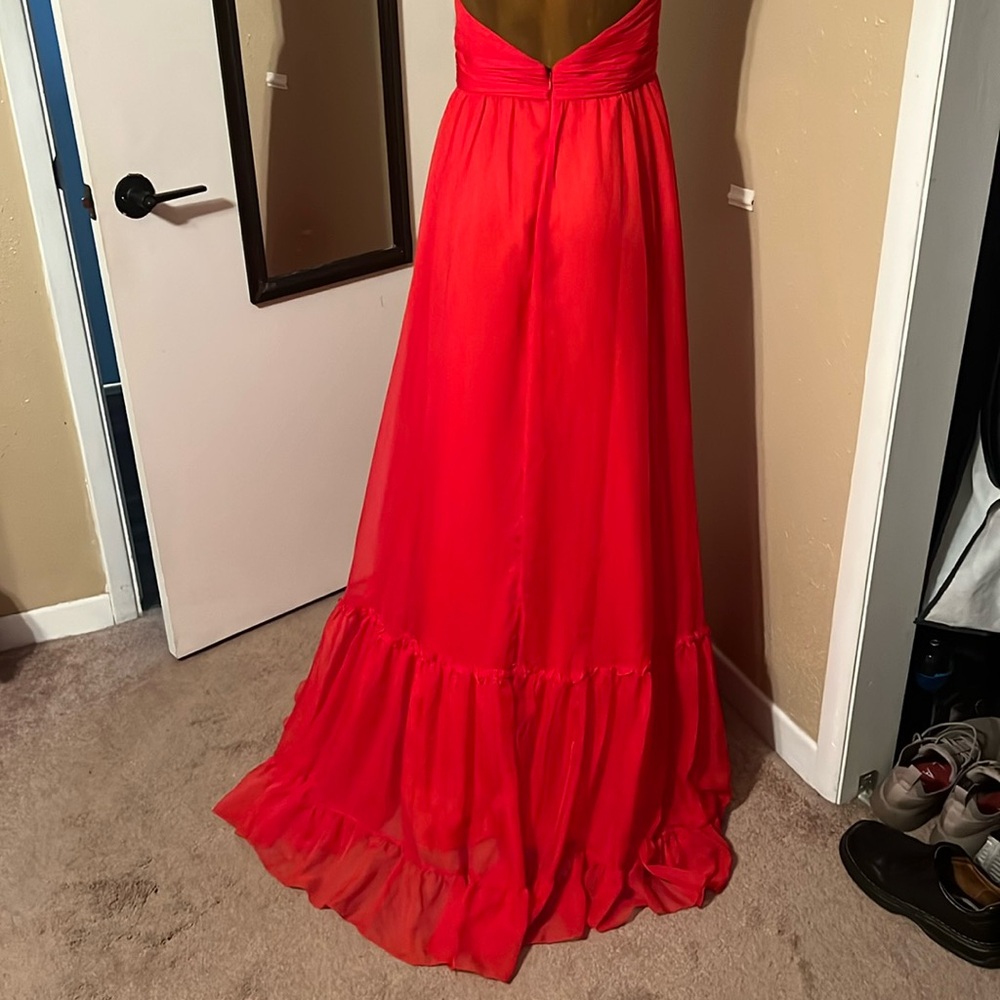 Beautiful red soft and flowy Mac Duggal gown with high neck.